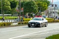 Tokyo 2020 Olympic Torch Relay. Car parade with police car ensuring safety in Fuji City, Japan