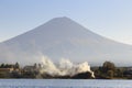 Fuji mountain view from Kawaguchi lake with smoke on the land, Kawaguchigo, Japan. Royalty Free Stock Photo