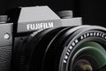 Fujifilm camera with fujinon aspherical lens on black background