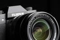 Fujifilm camera with fujinon aspherical lens close-up on black background