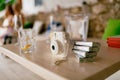 Fujifilm Instax Square SQ1 white camera with spare film cartridges stands on a wooden table Royalty Free Stock Photo