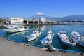 Fujiyama, Japan, April 10, 2023 : Fuji Mountain and Fisherman boats with Japan industry factory area background view from