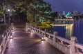 Kangetsu bridge lighted-up crossing the pond of Ohori Park with Ukimi-do Pavilion in background.