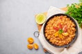 Ful Medames or Fava Beans in black bowl at grey backdrop. Foul Mudammas is a Egyptiancuisine breakfast dish