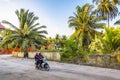 FULAHMULAH, MALDIVES - 9 APRIL, 2017: Two women in Muslim clothing ride a moped on the equatorial island Fulahmulah, Maldives