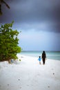 Muslim woman and child are walking in the beach of island small village Royalty Free Stock Photo