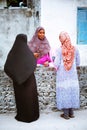 Muslim women are talking in the street of island small village Royalty Free Stock Photo