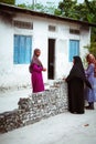 Muslim women are talking in the street of island small village Royalty Free Stock Photo