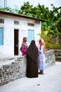 Muslim women are talking in the street of island small village Royalty Free Stock Photo