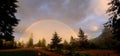 Full arc rainbow against a gray sky