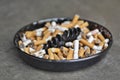 Full ashtray of cigarettes on table, close-up Royalty Free Stock Photo