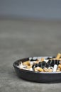 Full ashtray of cigarettes on table, close-up Royalty Free Stock Photo