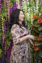 Full Asian woman in the room with flowers. Royalty Free Stock Photo