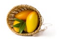 Full basket of mango with green leaf isolated