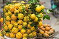 Full basket of orange fruit on vendor bike on Hanoi street, Vietnam
