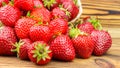 Full basket of strawberries that are poured out on table