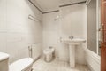 A full bathroom with showers with screens, white porcelain toilets