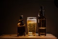 Full beer bottle on a wooden table and a glass of beer Royalty Free Stock Photo