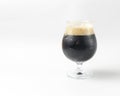 Full beer tulip glass of stout or porter isolated on white background. Beer in a glass, alcoholic beverage