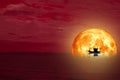 full blood moon back silhouette boat on night sea