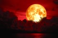 Full blood moon over silhouette heap cloud on the sea Royalty Free Stock Photo