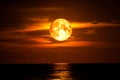 Full blood moon on sea and ocean light sky silhouette cloud