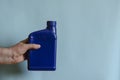 Full blue canister in a man`s hand