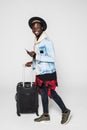 Full body of African american business man traveling with suitcases walking on white background Royalty Free Stock Photo