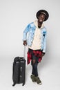 Full body of African american business man traveling with suitcases walking on white background Royalty Free Stock Photo