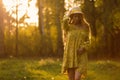 Blond woman resting in forest at sunset