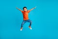 Full body cadre of jumping energetic latin small kindergarten age boy hands up positive star symbol hands isolated on