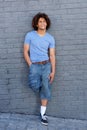 Full body cool young guy with curly hair smiling Royalty Free Stock Photo