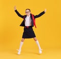 Excited schoolgirl jumping high in studio Royalty Free Stock Photo