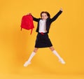 Excited schoolgirl jumping high in studio Royalty Free Stock Photo