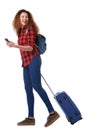 Full body happy travel woman walking with suitcase and mobile phone Royalty Free Stock Photo