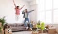 Excited couple celebrating relocation in new apartment Royalty Free Stock Photo