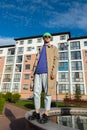 Full body happy youngster in a trendy outfit against a street background