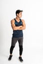 Full body image asian muscular man standing wearing gym clothes with crossed hands
