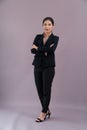 Confident young businesswoman stands on isolated background. Enthusiastic Royalty Free Stock Photo