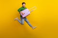 Full body length photo of crazy screaming young man guitarist holding luggage suitcase jumper singing isolated on yellow