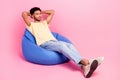 Full body length photo of dreaming sleeping young guy take nap hands head lying beanbag comfortable place isolated on