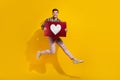 Full body length photo of funky guy in air jumping with red heart subscribe share repost click like on yellow