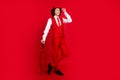 Full body length photo of handsome model boyfriend touching his hat standing with vintage parasol  on red color Royalty Free Stock Photo