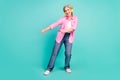 Full body length photo pensioner woman in pink shirt dancing boogie woogie listen music earphones isolated on blue color