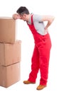 Full body of man having a back pain leaning on boxes Royalty Free Stock Photo