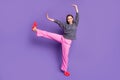 Full body photo of active ballerina girl in dotted pink pajama raise hands legs imagine she do rest relax exercises wear
