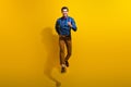 Full body photo of active energetic optimistic man wear bow tie stylish shirt hurry running shopping isolated on yellow
