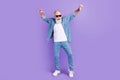 Full body photo of aged man happy positive smile have fun dance party isolated over violet color background Royalty Free Stock Photo