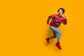 Full body photo of astonished excited woman wear sweater fast running look at logo empty space isolated on yellow color Royalty Free Stock Photo