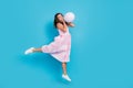 Full body photo of attractive beautiful girl jump balloon blow air cheeks celebrate isolated on blue color background